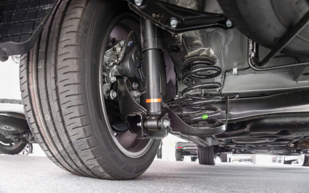 View of a car rear axle assembly with control arm and air suspension shock absorber.
